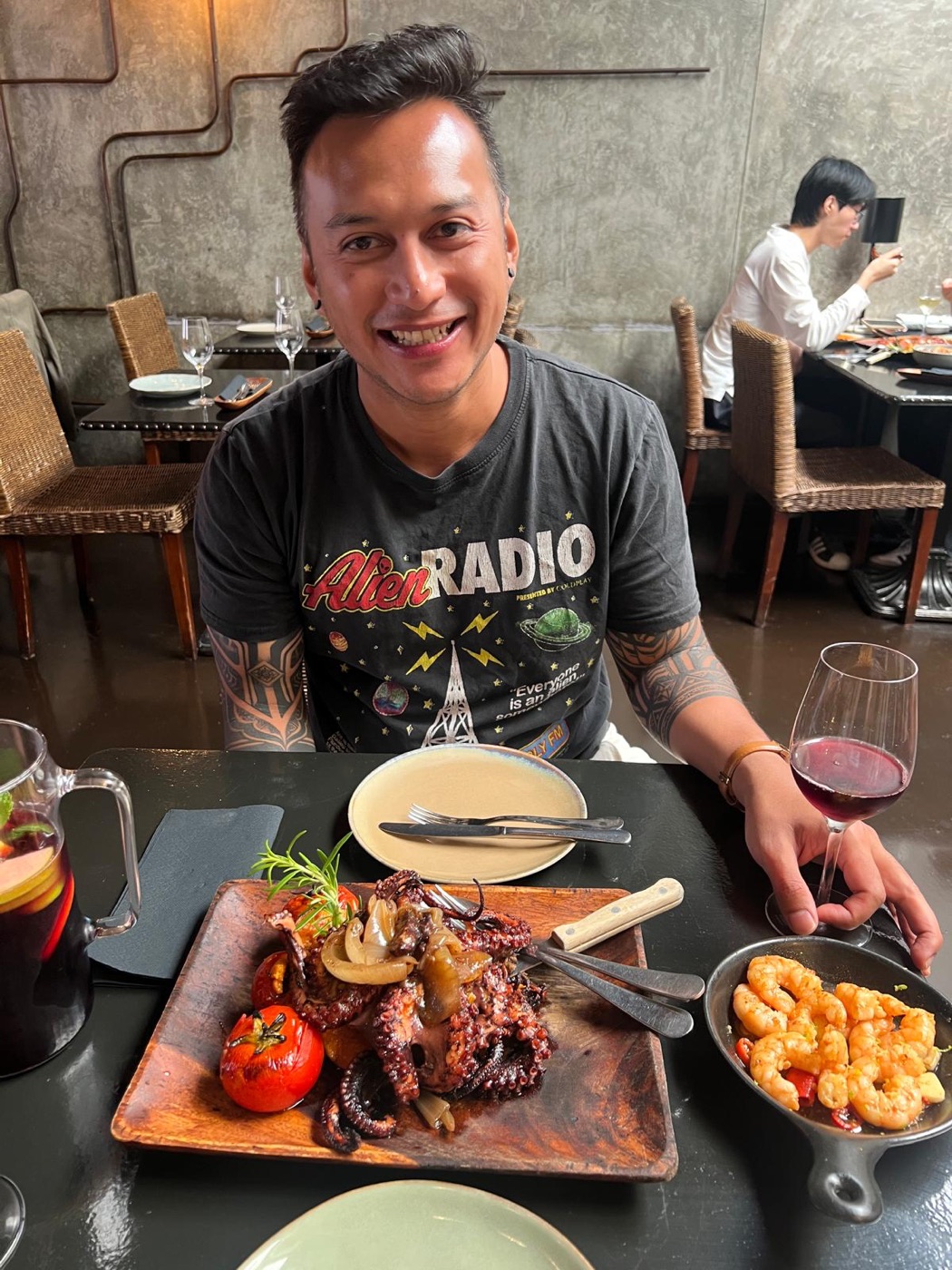 Portrait of Jan Donyada, smiling at a restaurant table.