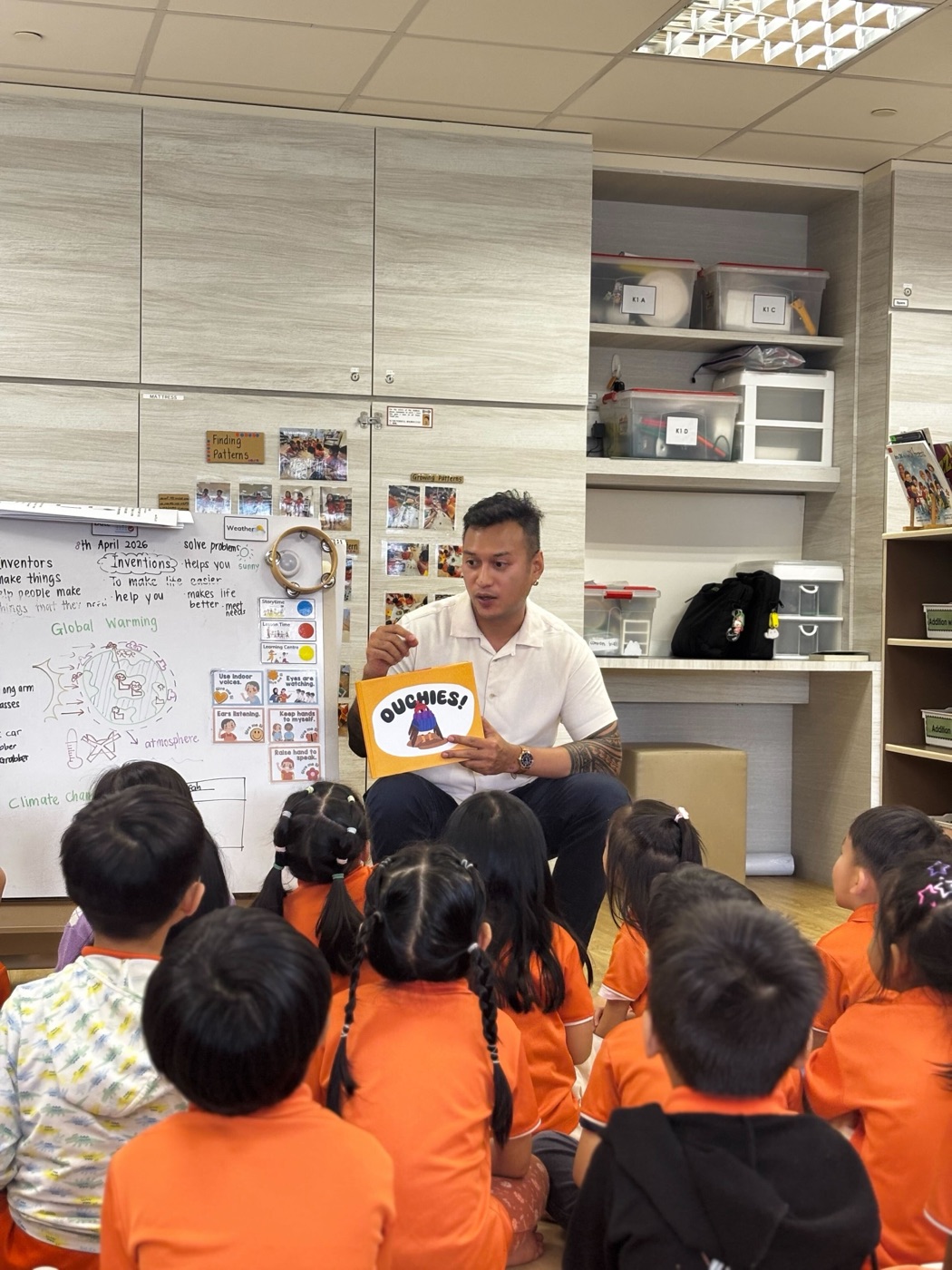 Jan reading the Ouchies! picture book to a class of kindergarten children.